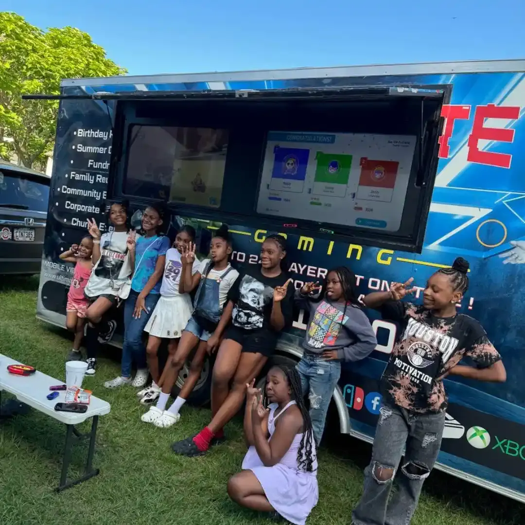 Group of kids posing in front of the Ultimate Mobile Gaming truck at an Atlanta birthday party